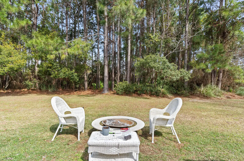 186 Shipwreck Road Santa Rosa Beach, FL 32459 - Photo 30 of 37 a view of a chairs and table in backyard