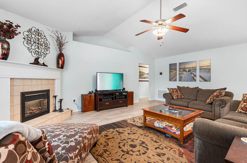 186 Shipwreck Road Santa Rosa Beach, FL 32459 - Photo 10 of 37 a living room with furniture a fireplace and a flat screen tv