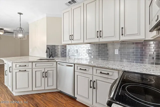 a kitchen with white cabinets and white appliances