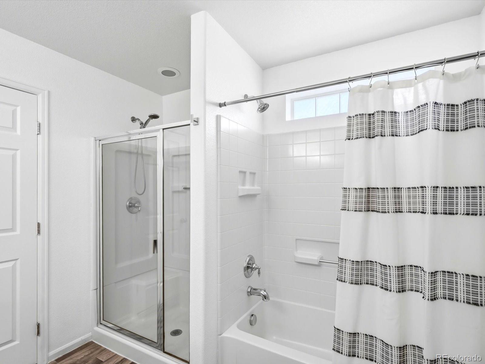5444 Perth Court Denver, CO 80249 - Photo 29 of 46 a bathroom with a shower and a bath tub