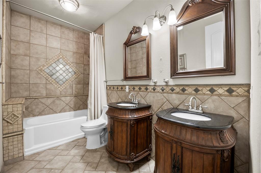 219 Mohundro Road Ferris, TX 75125 - Photo 28 of 40 a bathroom with a sink a toilet and shower