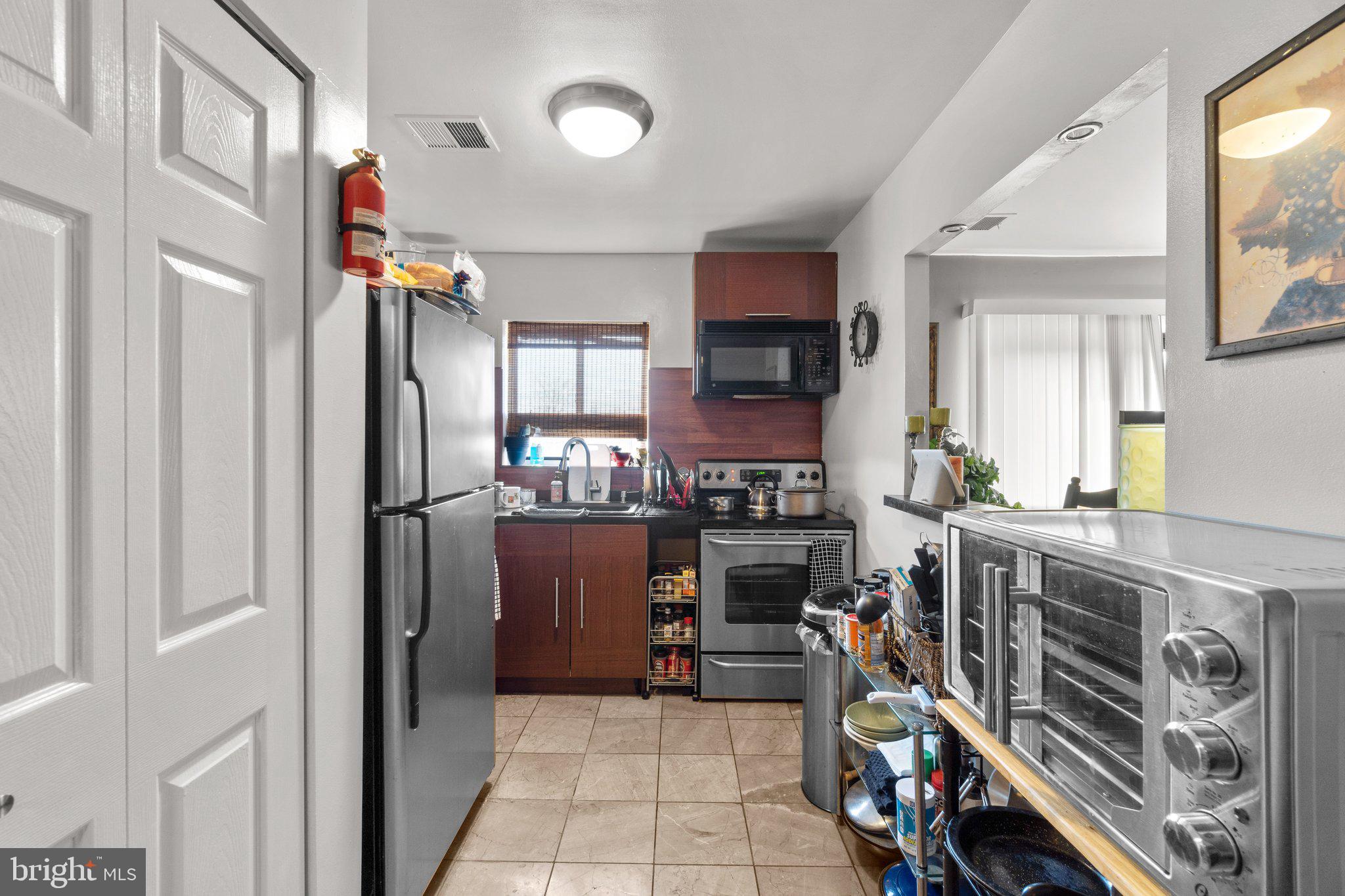 3928 Rolling Rd., Unit C9 Pikesville, MD 21208 - Photo 12 of 23 a kitchen with a refrigerator and a stove