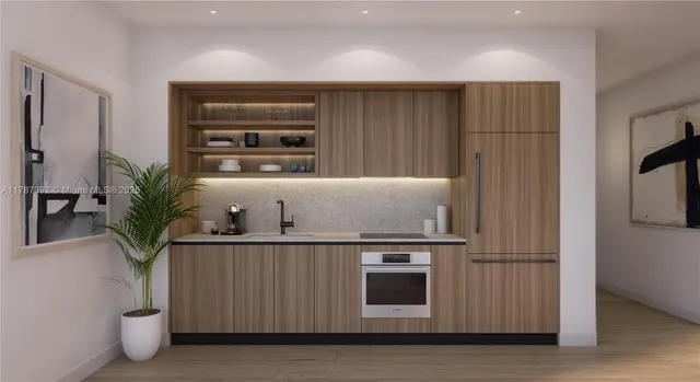 a kitchen with stainless steel appliances a microwave and a potted plant