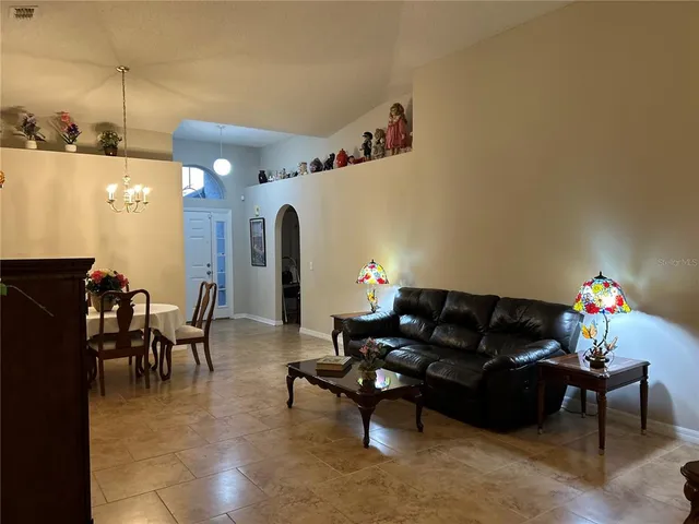 a living room with furniture and a lamp