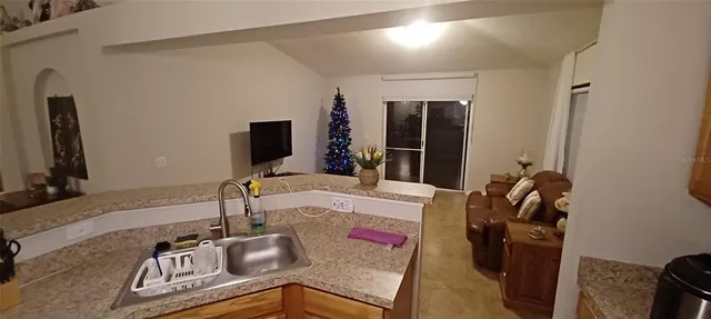 a kitchen with sink stove and refrigerator
