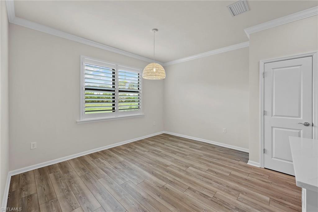 2236 Yellowfin Circle Naples, FL 34114 - Photo 16 of 39 wooden floor in an empty room with a window