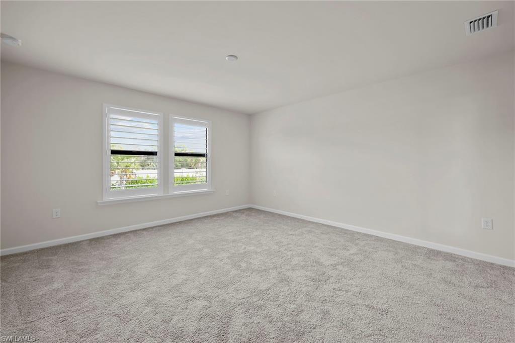 2236 Yellowfin Circle Naples, FL 34114 - Photo 19 of 39 an empty room with windows