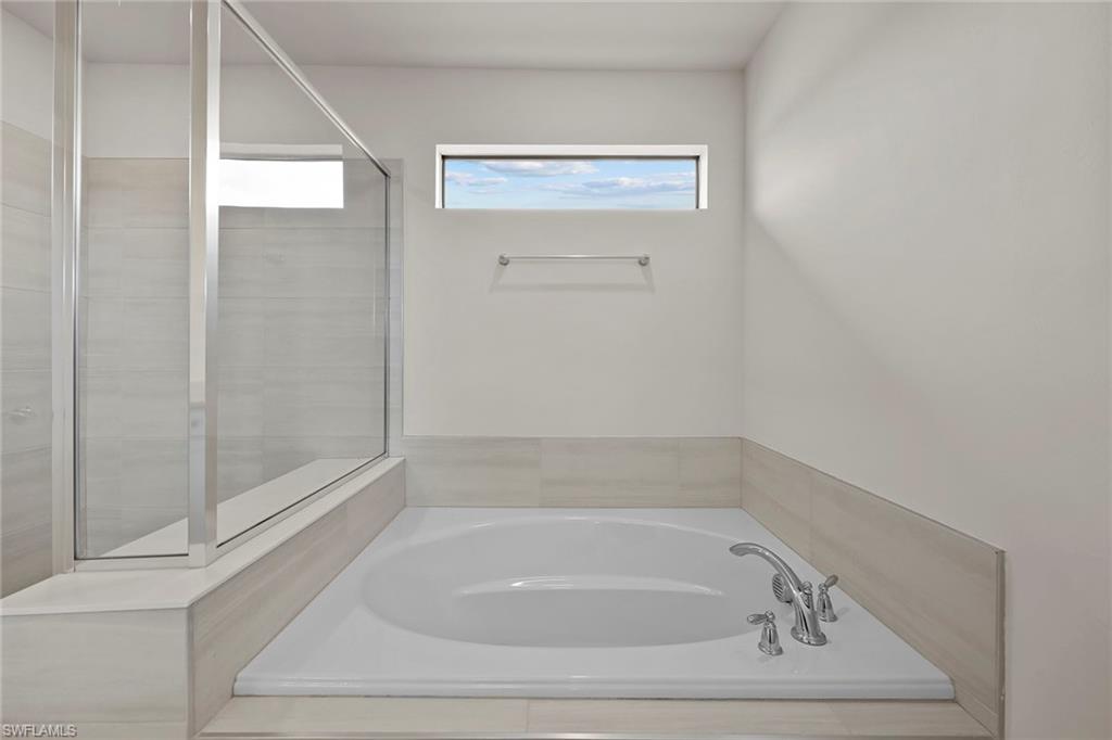 2236 Yellowfin Circle Naples, FL 34114 - Photo 21 of 39 a bathroom with a bathtub