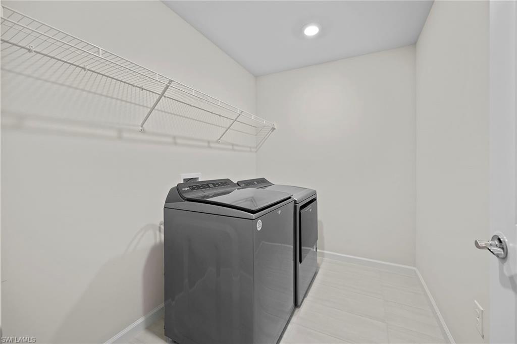 2236 Yellowfin Circle Naples, FL 34114 - Photo 27 of 39 a utility room with dryer and washer
