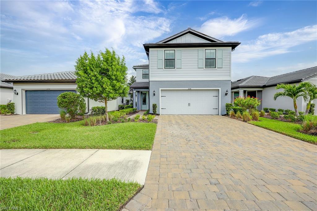 2236 Yellowfin Circle Naples, FL 34114 - Photo 3 of 39 a front view of a house with a yard and garage
