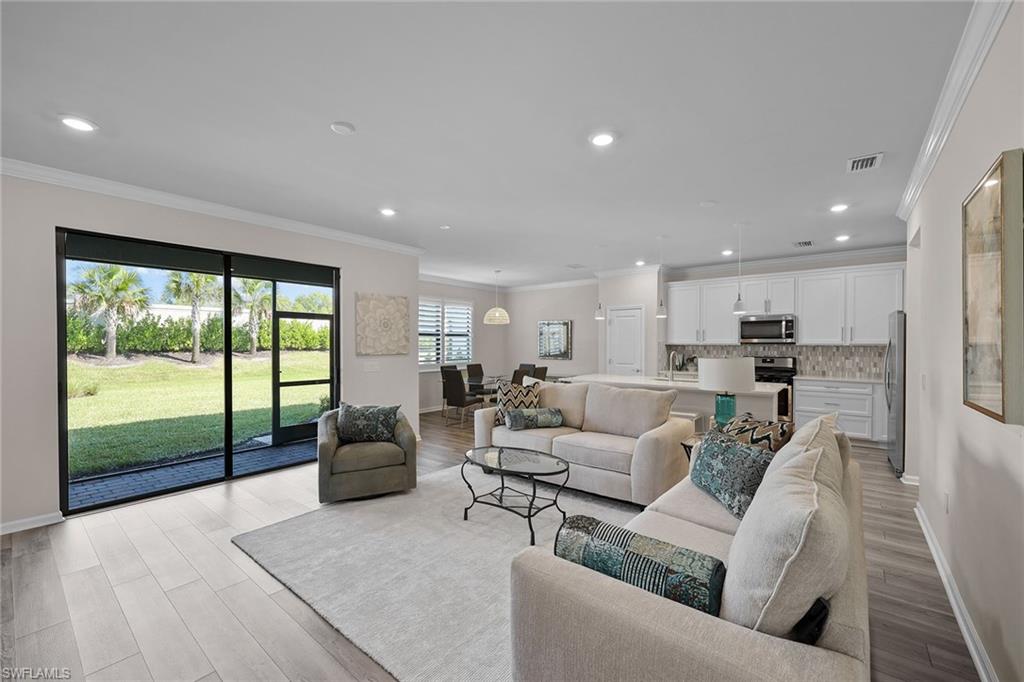 2236 Yellowfin Circle Naples, FL 34114 - Photo 4 of 39 a living room with furniture and a large window