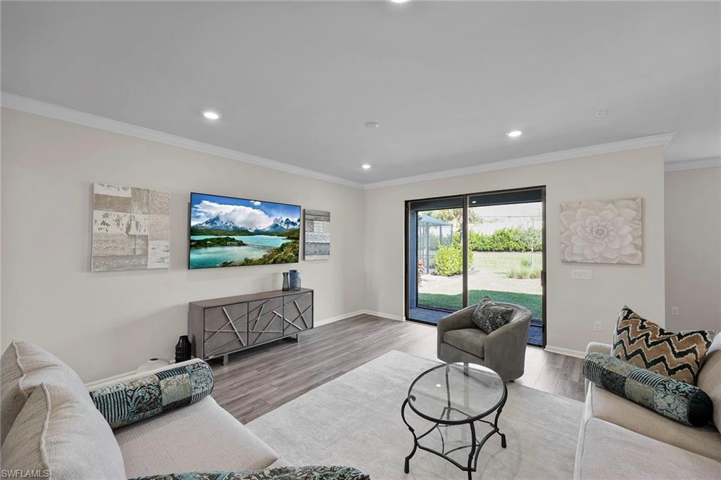 2236 Yellowfin Circle Naples, FL 34114 - Photo 5 of 39 a living room with furniture and a flat screen tv