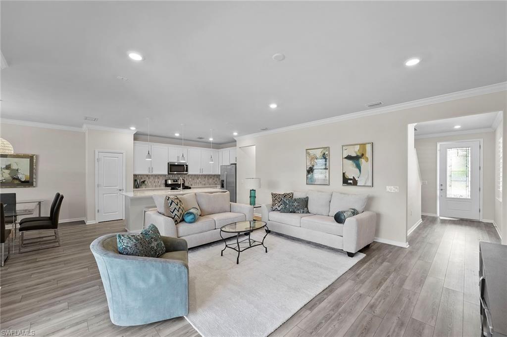 2236 Yellowfin Circle Naples, FL 34114 - Photo 7 of 39 a living room with furniture and a wooden floor
