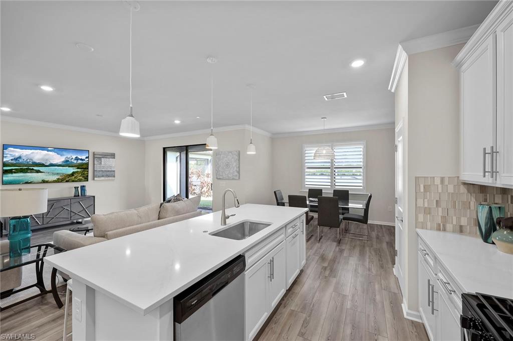 2236 Yellowfin Circle Naples, FL 34114 - Photo 9 of 39 a large kitchen with sink a counter space and appliances