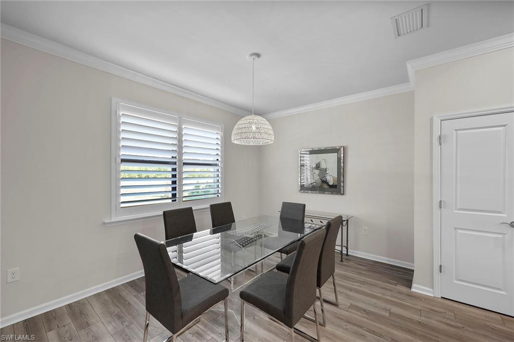 2236 Yellowfin Circle Naples, FL 34114 - Photo 10 of 39 a view of a dining room with furniture window and wooden floor