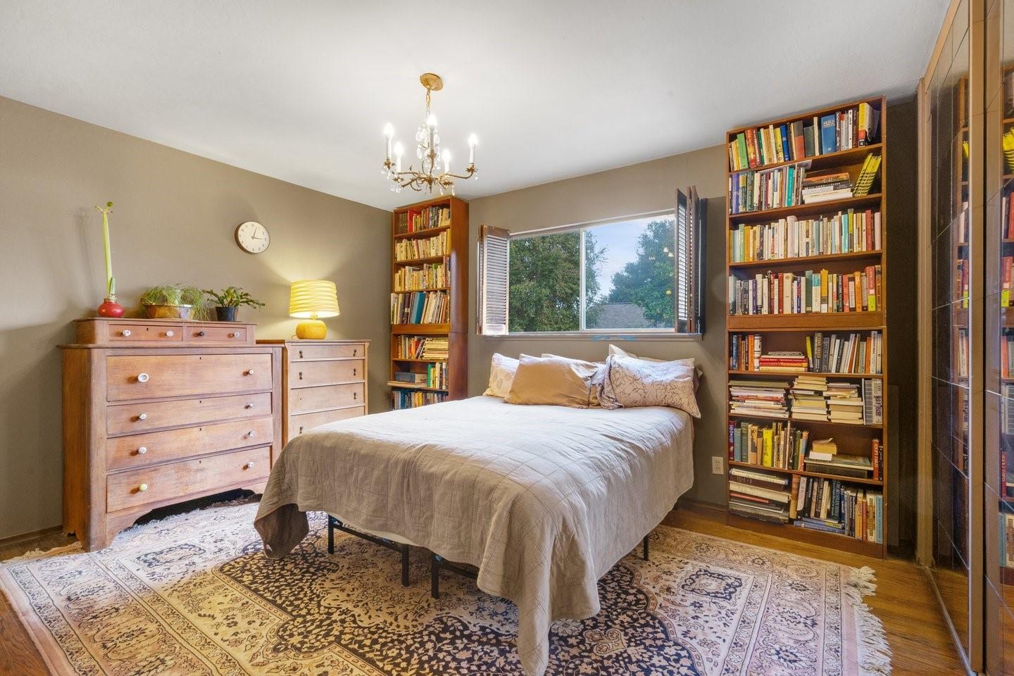 1374 Primrose Way Cupertino, CA 95014 - Photo 29 of 35 a bedroom with a bed a bookshelf and a bookshelf