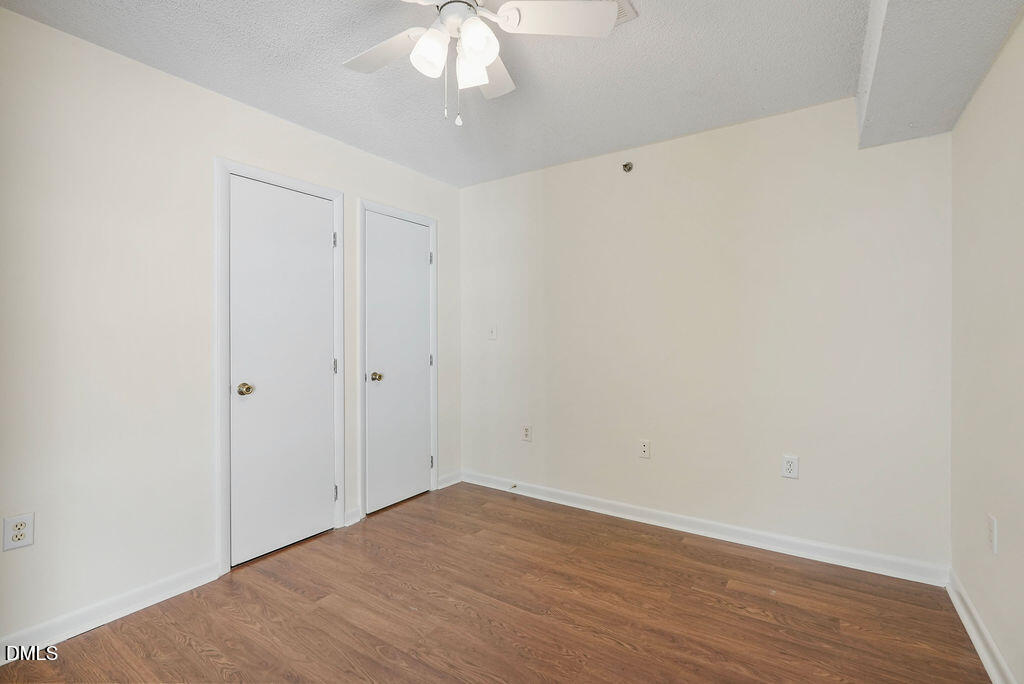 1411 Collegiate Circle, Unit 302 Raleigh, NC 27606 - Photo 11 of 43 a view of an empty room with wooden floor