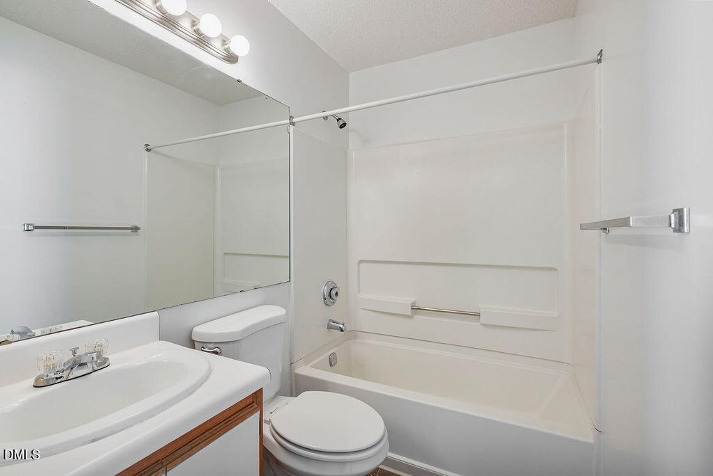 1411 Collegiate Circle, Unit 302 Raleigh, NC 27606 - Photo 14 of 43 a bathroom with a shower a toilet and sink