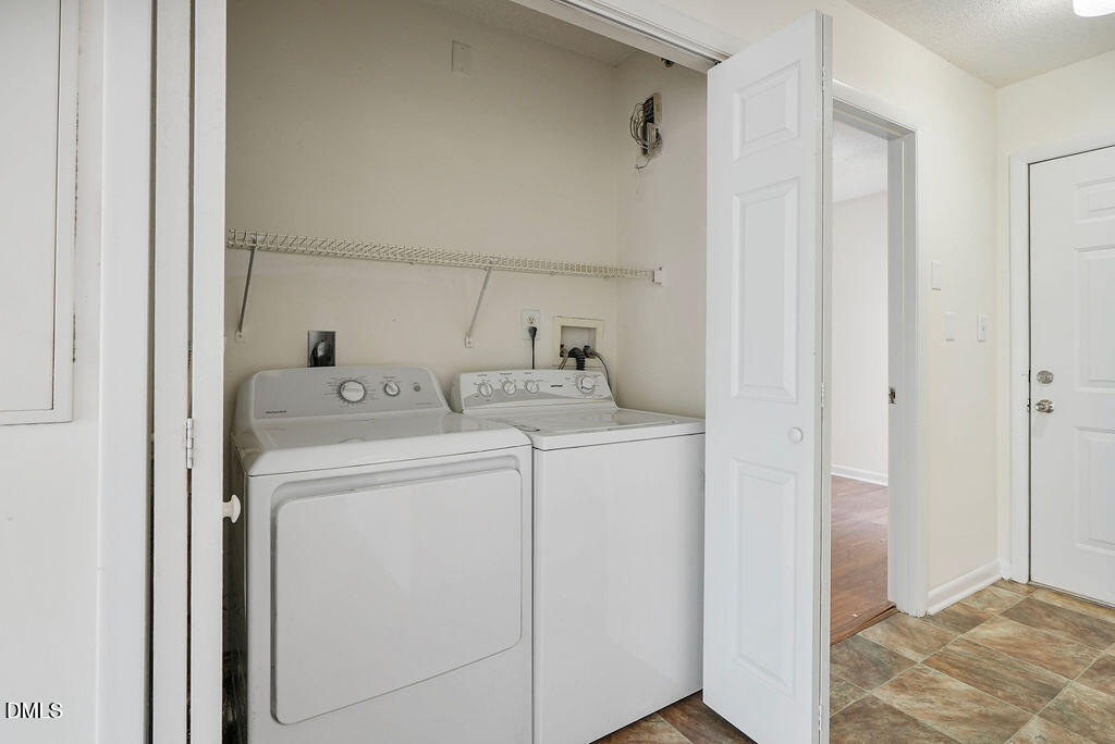1411 Collegiate Circle, Unit 302 Raleigh, NC 27606 - Photo 29 of 43 a utility room with dryer and washer