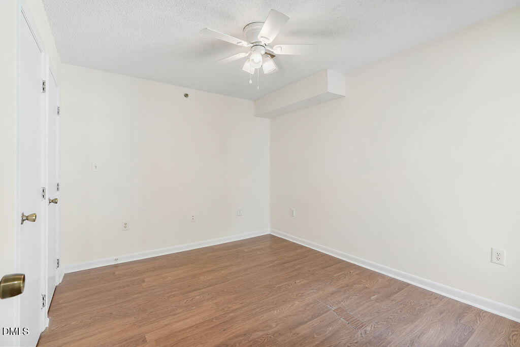 1411 Collegiate Circle, Unit 302 Raleigh, NC 27606 - Photo 10 of 43 a view of a room with a fan and a fan