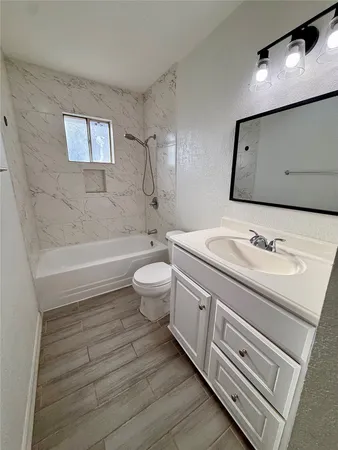 a bathroom with a sink a toilet and bathtub