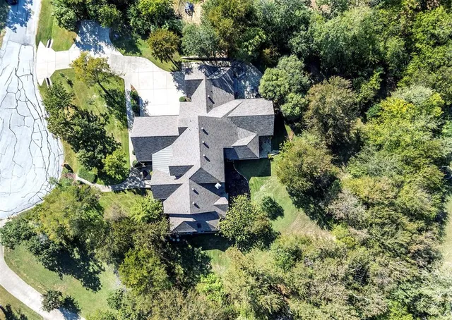 an aerial view of a house with a yard