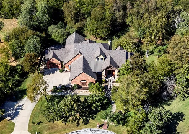 an aerial view of a house with swimming pool and garden space