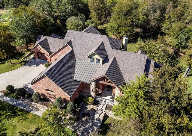 an aerial view of a house with garden space and street view