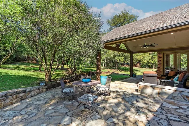a view of a patio with a table chairs and a backyard