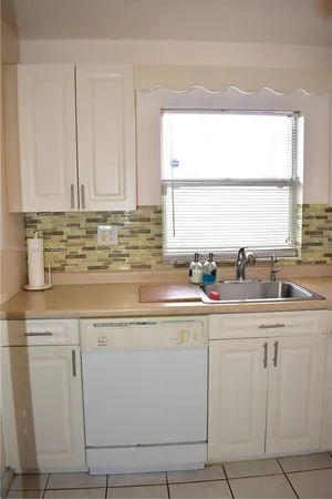 a kitchen with cabinets appliances and a sink
