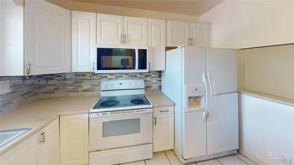 a kitchen with a stove sink and refrigerator