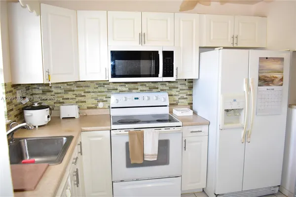 a kitchen with a stove and a refrigerator