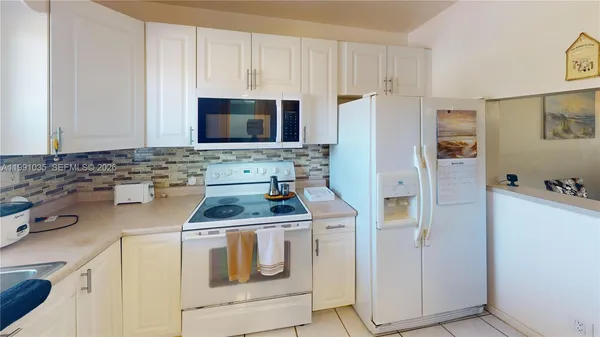 a kitchen with a stove sink and refrigerator