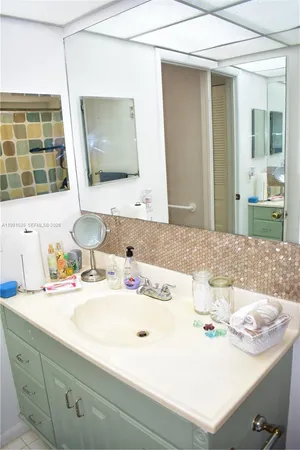 a bathroom with a sink and a mirror