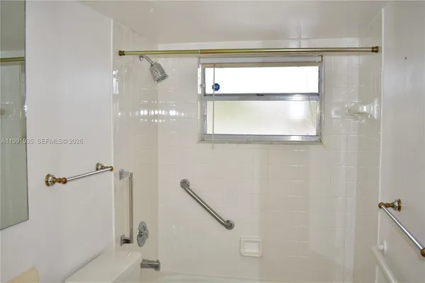 a bathroom with a glass shower door