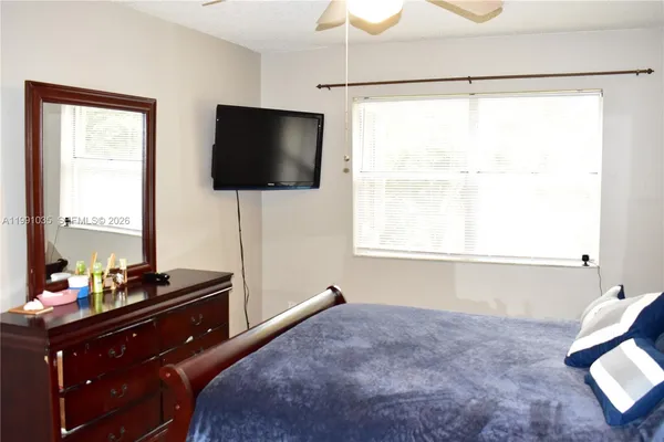 a living room with flat screen tv and a window