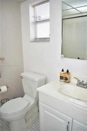 a white toilet sitting next to a bathroom sink