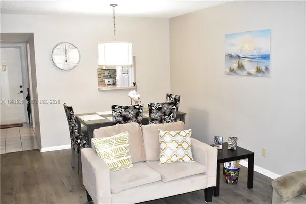 a living room with furniture and wooden floor
