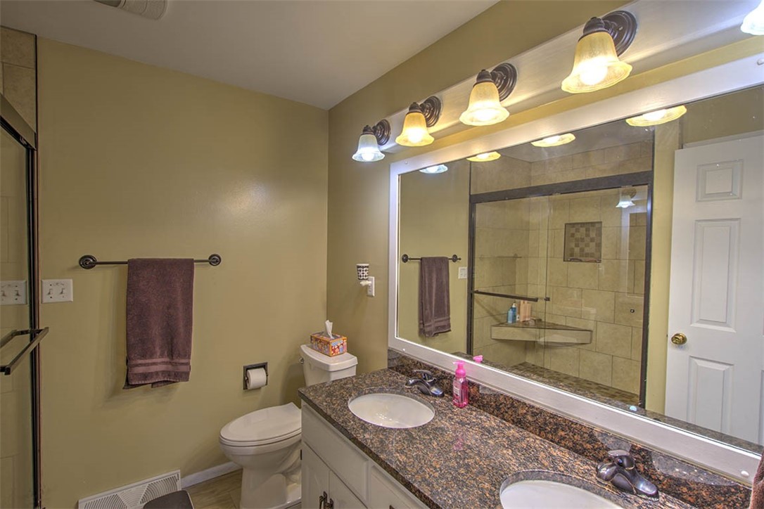 120 Point Bluff Drive Decatur, IL 62521 - Photo 17 of 34 a bathroom with a granite countertop sink toilet a mirror and shower