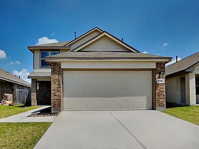 a front view of a house with a yard and garage