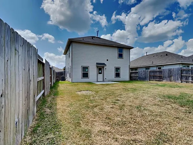 a view of a house with a backyard