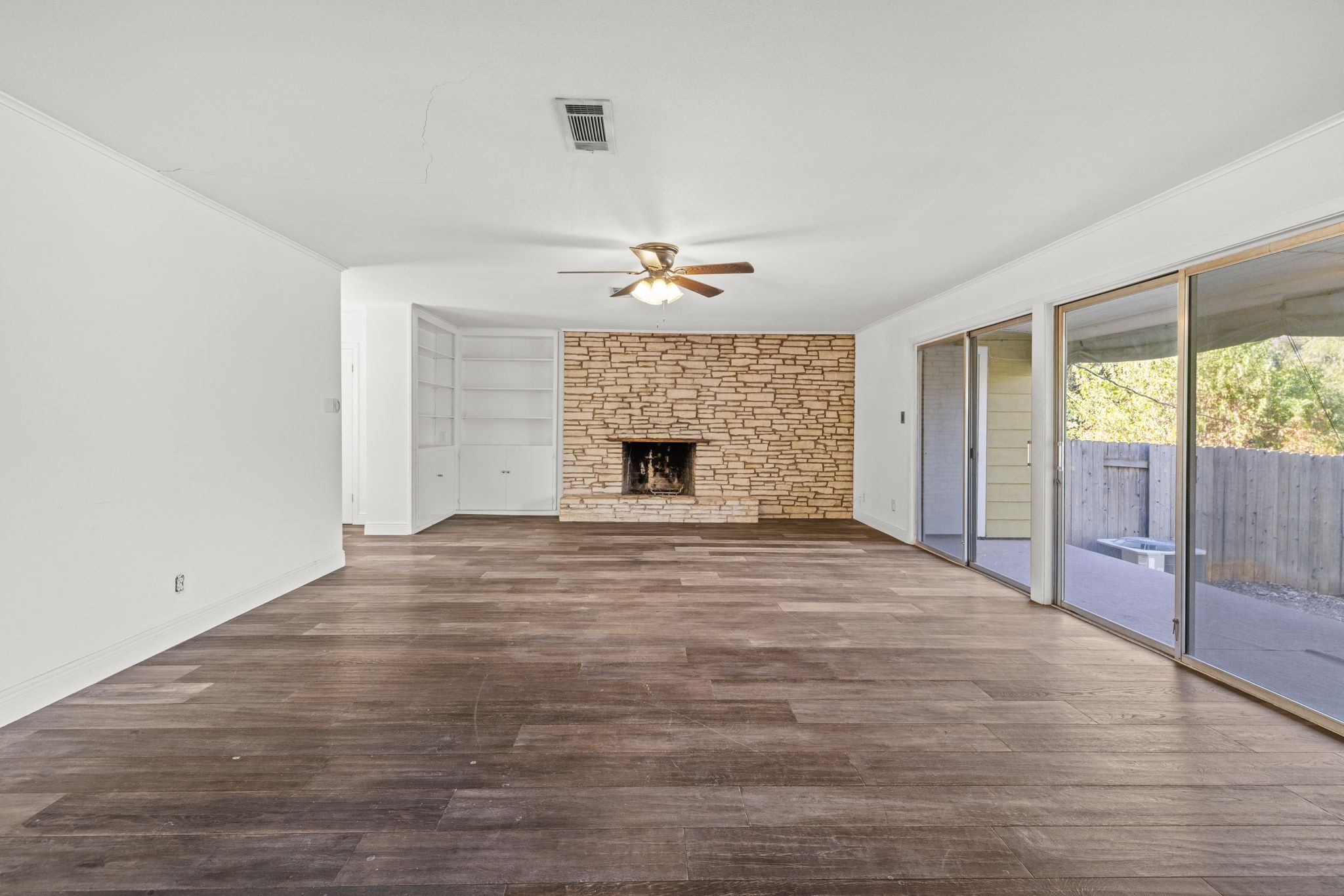 2326 Hartford Road, Unit 1/2 Austin, TX 78703 - Photo 13 of 28 wooden floor in an empty room with a fireplace