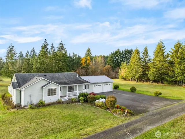 an aerial view of a house with a big yard