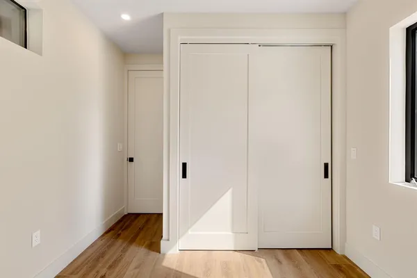 a view of hallway with wooden floor