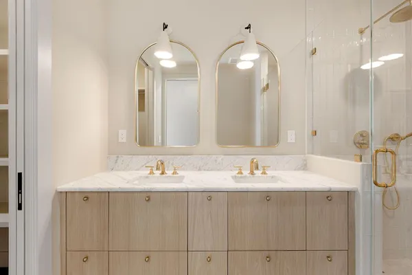 a bathroom with a sink double vanity and a mirror