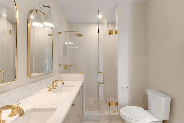 a bathroom with a granite countertop sink toilet and shower