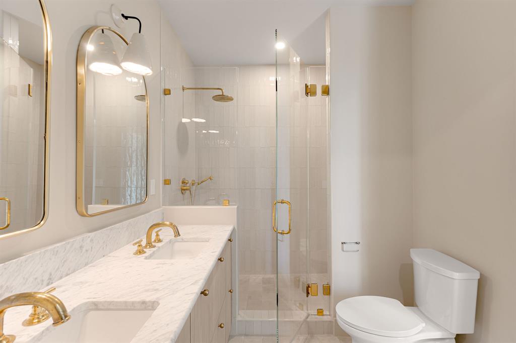 4414 Banister Lane, Unit 2 Austin, TX 78745 - Photo 21 of 28 a bathroom with a granite countertop sink toilet and shower