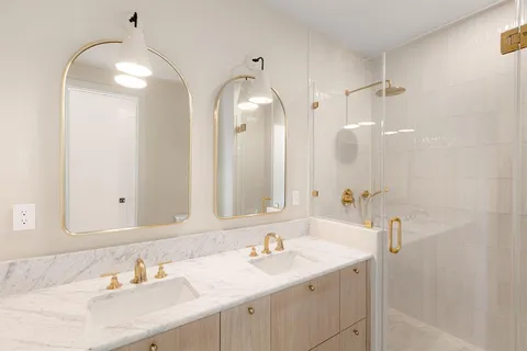 a bathroom with a sink double vanity and a mirror