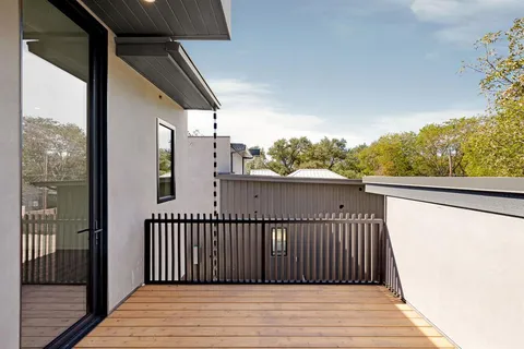 a view of a balcony with wooden floor