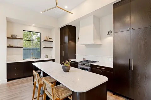 a kitchen with a table chairs and refrigerator